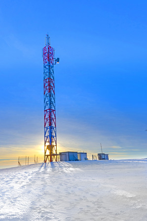Telecommunications Tower at sunset winter landscapeの写真素材