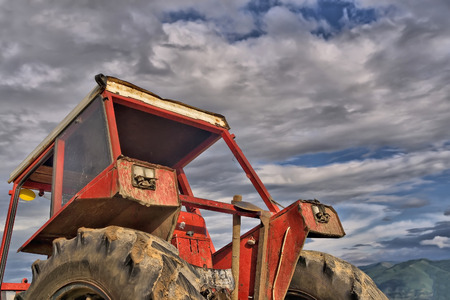 Old tractor on the grass fieldの写真素材