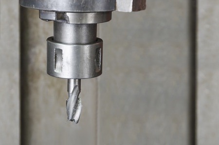 Metal workshop, Drill machine closeup. - Stock Image. Macro shot from slight high angleの写真素材