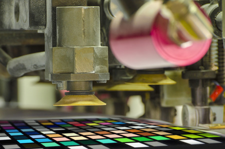 offset machine press print run at table; color patch detailの写真素材