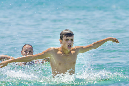 Healthy lifestyle  Couple having fun at the ocean, sea swimming, splashing の写真素材
