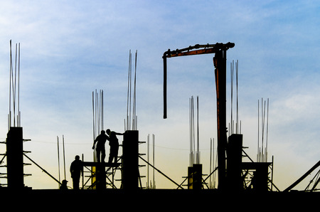 building skyscraper construction site silhouette crane working filling the posts with concrete