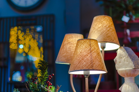 modern vibrant table lamp and christmas lights at backgroundの写真素材