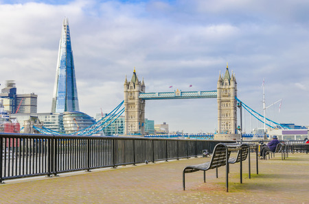 The Shard and Tower Bridge with an empty bench in London, UKの写真素材