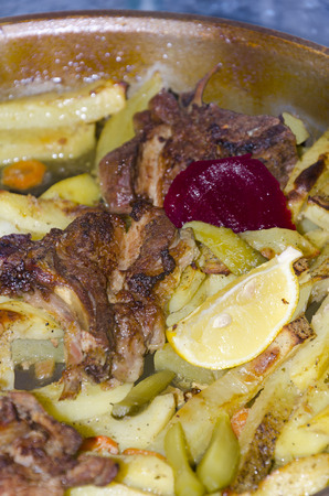 roast meet with potatoes, lemon and spices, old traditional wayの写真素材