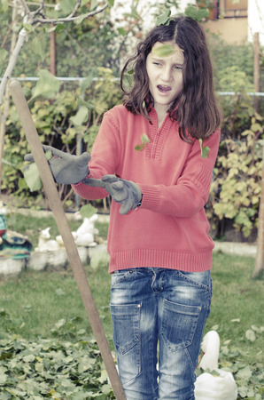 aware young girl waiting for the stick not hiting her in the gardenの写真素材