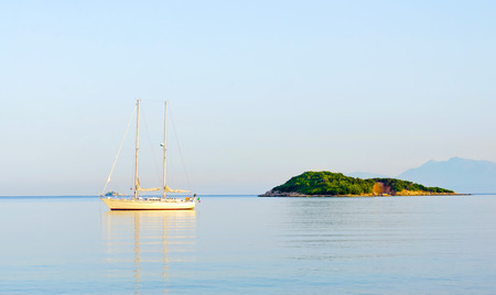 Sailing boat at anchor. Paradise wild bay and islandの写真素材