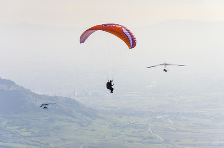 paraglider and two gliders do extreme adrenaline sport flight. Aerial povの写真素材