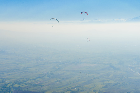 Amazing aerial pov of paraglider fly on high altitude with clear blue akyの写真素材