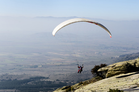 Paraglider taking off from a mountainの写真素材