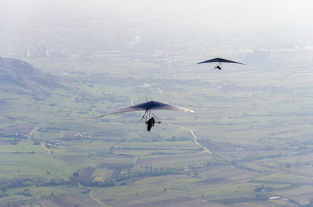 aerial view pov of two gliders fly over valleyの写真素材
