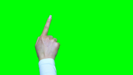 Hand gestures. Touchscreen. Female hand showing multitouch gestures in green screenの写真素材