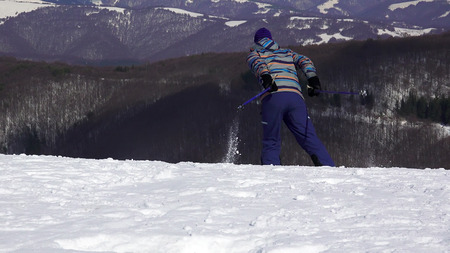 Rear View Of Skier START Skiing Down The Snowy Slopeの写真素材