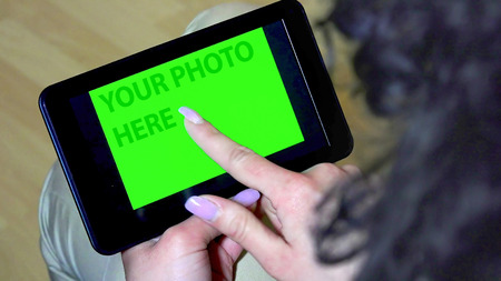 Green screen hands using digital tablet touchscreen device, holding tablet screen touchpad womanの写真素材