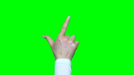 Hand gestures. Touchscreen. Female hand showing multitouch gestures in green screenの写真素材