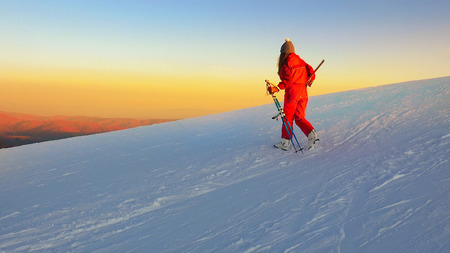 Backcountry skier (ski touring), walks up to a snowed mountain ridgeの写真素材