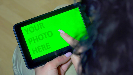 Green screen hands using digital tablet touchscreen device, holding tablet screen touchpad womanの写真素材