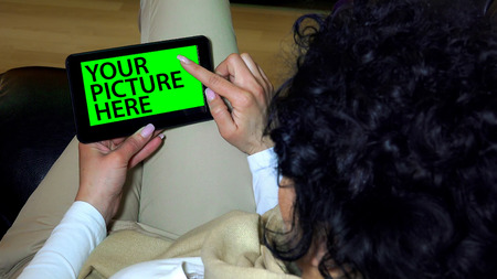Holding Touchscreen Device, Close-up of female hands using a smart phone. chroma-key, green-screenの写真素材