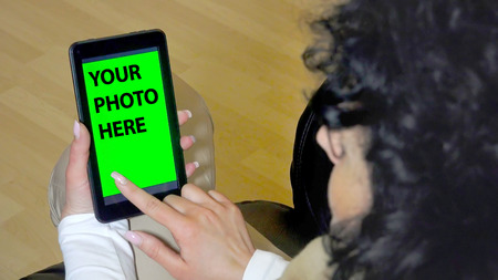 Green screen hands using digital tablet touchscreen device, holding tablet screen touchpad womanの写真素材