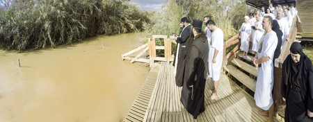 YERICHO, ISRAEL - 20 FEB, 2017: Christian pilgrims during mass baptism ceremony at the Jordan River in North Israel.In Christian tradition, Jesus was baptised in the River Jordan by John the Baptistのeditorial素材