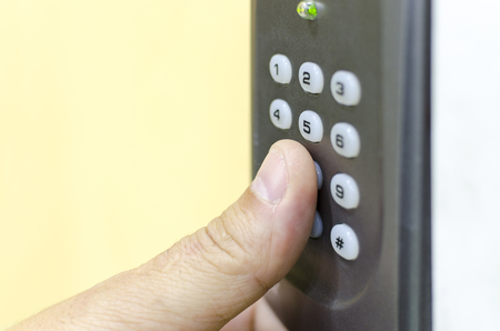 Opening the door with number combination with handの写真素材