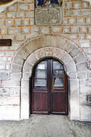 Wooden door on brick wall churchの写真素材
