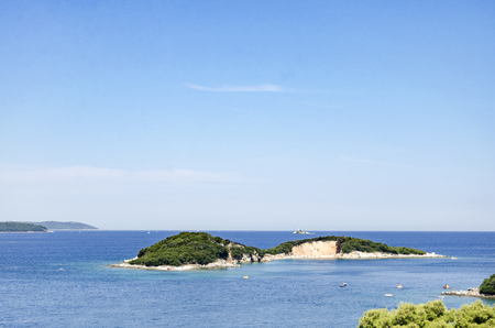 Beautiful Mediterranian island with white beach seen from the seaの写真素材