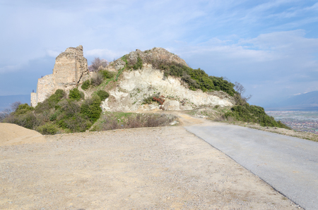 Ruins of ancient fortress, asphalt road to ruined defense tower, Macedoniaの写真素材