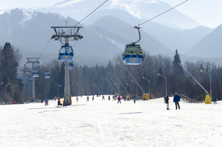 BANSKO, BULGARIA - 07 FEB, 2017: Blue gondola cabin lifts at a ski resort transport people from town to ski slopes in mountainのeditorial素材