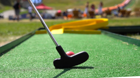 Closeup of player play mini golf with red ballの写真素材