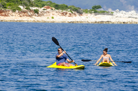 Young caucasian couple kayaking in seaの写真素材