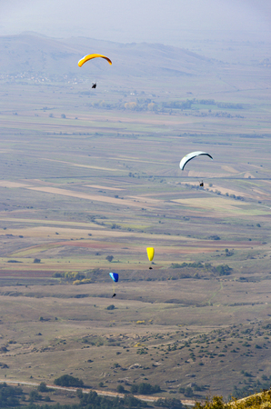 Paraglider flying over valley, aerial view povの写真素材