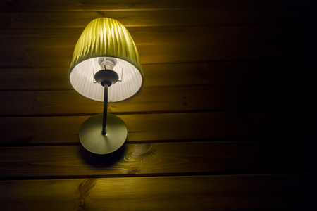 Urban background. Wooden wall under the lamp light at nightの写真素材