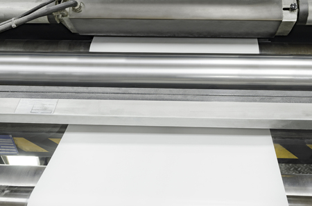Polygraphic process and white paper and rollers on large print machine  in a modern printing houseの写真素材
