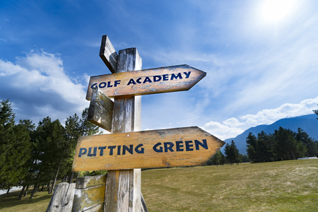 Signpost with golf course information on the wooden sign arrows.の写真素材