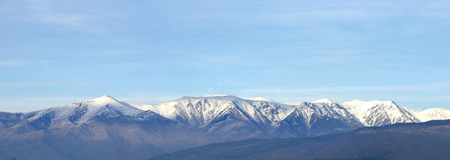 Panorama of Snow Mountain Range Landscape with Blue Skyの写真素材