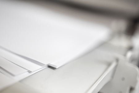 Laser Jet Digital Printer Printing paper with dof blur copyspace, focus on paper cornerの写真素材