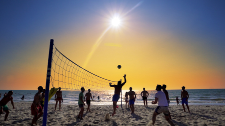 Silhouettes of young men playing volleyball on Varkala beach at sunset, Durres, Albania, SLOW MOTIONのeditorial素材