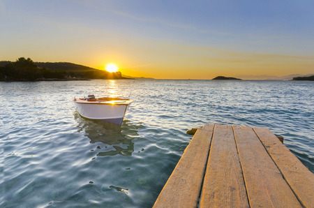Small Dock and Boat at the lake, sunset shotの写真素材