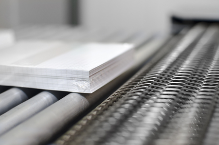 Close up of Paper stuck, book on Factory Conveyor Belt, selective focus dof backgroundの写真素材