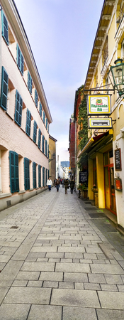 DUSSELDORF, GERMANY - MAR 01, 2017: People walk on treditional walkway pavement alley in Dusseldorf, Germanyのeditorial素材