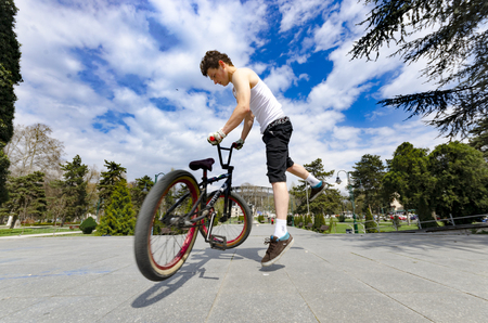 Skopje, Macedonia - circa Apr, 2013: Below view of bmx cyclist jumping against the skyのeditorial素材