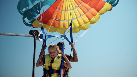 Family adrenaline fun excatment before take off at para sailing with a rope pulled by a boat. Paragliding is the most excited summer vacation atttractionのeditorial素材
