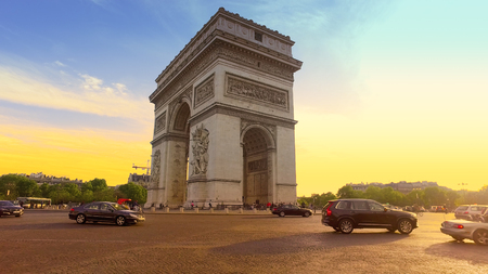 Traffic drives along Arc de Triomphe circle at Sunset. It is one of the most famous monuments in Paris.のeditorial素材