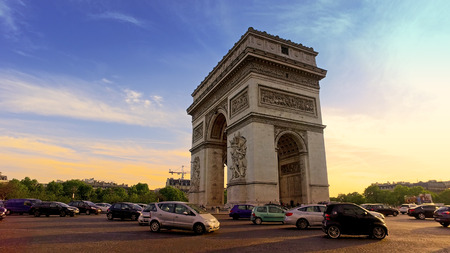 Low angle view of traffic at Arc de Triomph circle at sunset. This historical monument overlooks the avenue des champs lyses in the heart of French capital.のeditorial素材