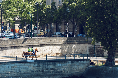 Paris, France - May 10, 2017: Mounted Police Ride Horse and Patrol in Paris on bank of Seine riverのeditorial素材
