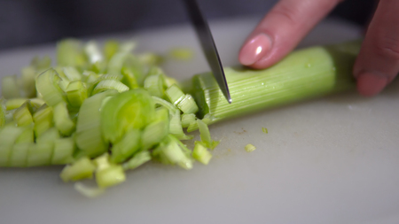 Chopping Leeks on a wooden board focus on sliced leeksの写真素材