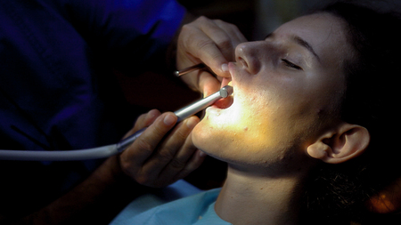 Girl at dentist during endodonic tooth channel filling applicationの写真素材