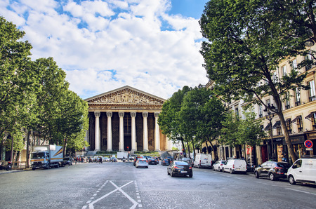 Street traffic at Madeleine church Paris France, a church Eglise Sainte Marie Madeleineのeditorial素材