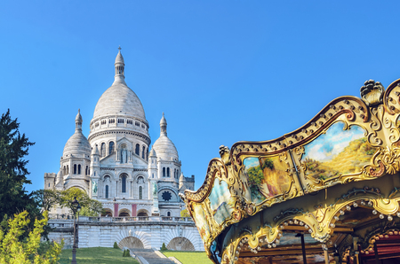 Basilica Sacre Coeur in Montmartre in Paris, France with closeup detail of vintage carouselの写真素材